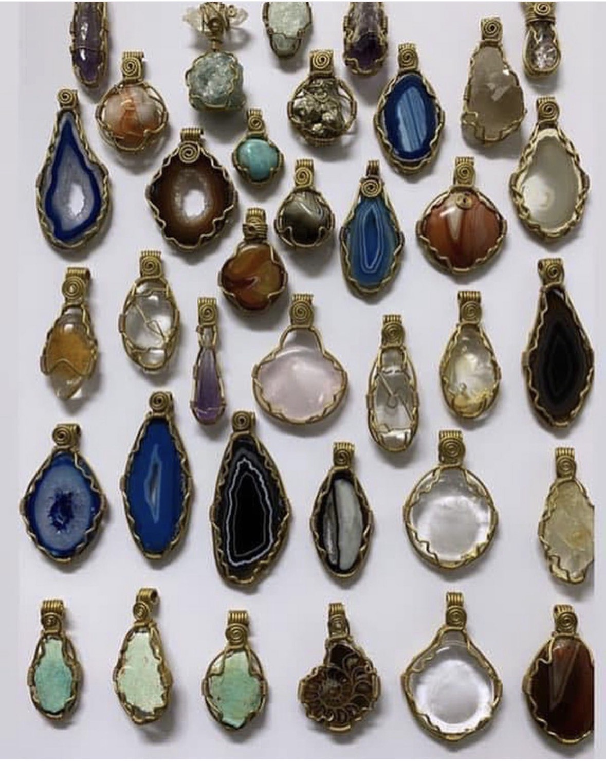 A full tray of hand-wrapped stone pendants