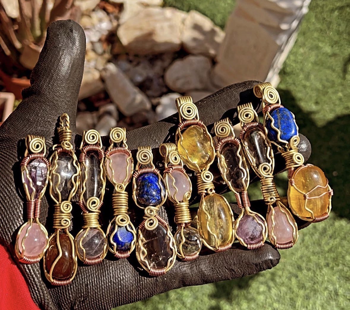 A handful of wire-wrapped gemstone pendants
