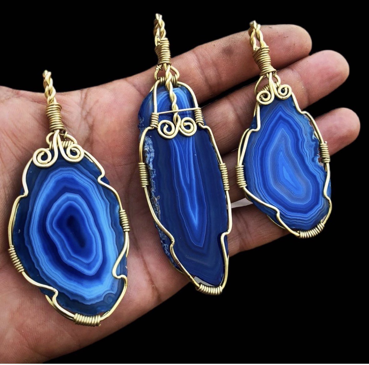 Three blue agate slice pendants in brass